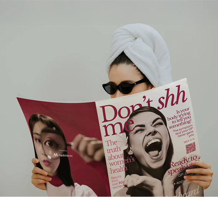 Person holding a magazine titled 'Don't shh me' with a cover featuring a woman's face.