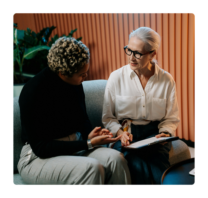 Two women talking in an office.