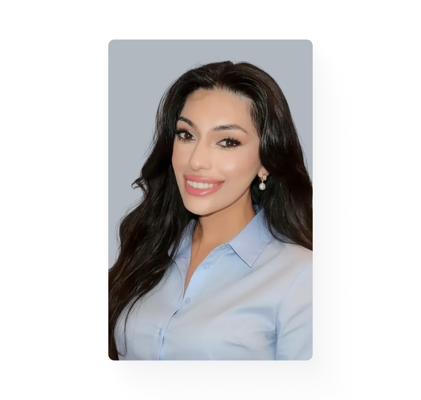 Young woman with long dark hair is smiling and looking at the camera.