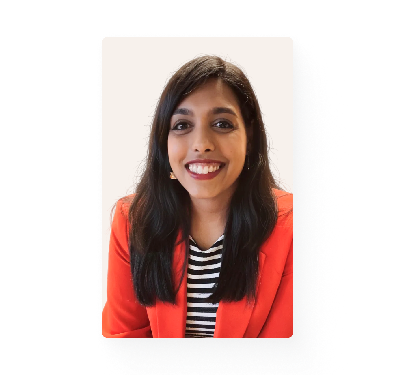 Young woman with long dark hair is smiling and looking at the camera.